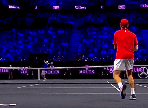 Tennis Player in Red Shirt Running on Court