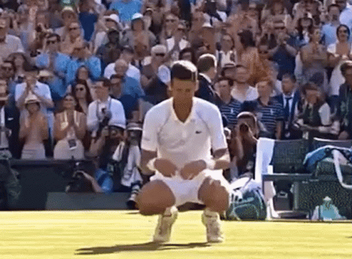 Tennis Player Kneeling in Front of Crowd
