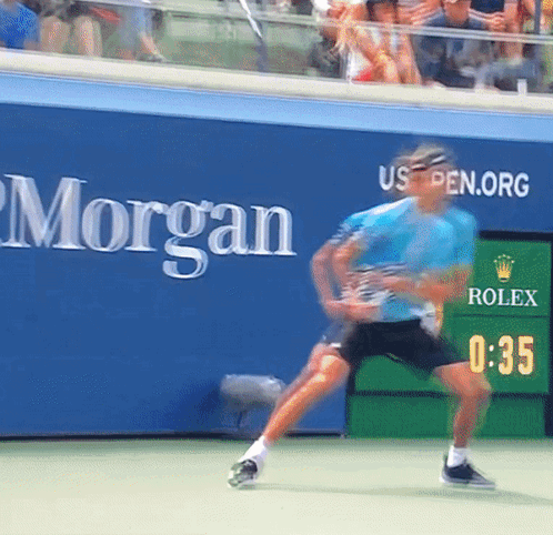Tennis Player Playing in Front of Morgan Sign