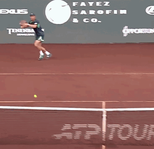 Tennis Player Running on Court in Front of Tennis Channel Banner