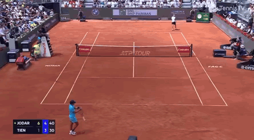 Tennis Player Swinging Racket in Front of EA7 Sign