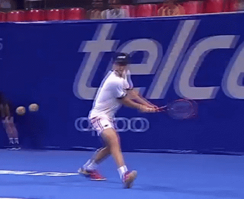 Tennis Player Swinging Racket in Front of Telcel Sign
