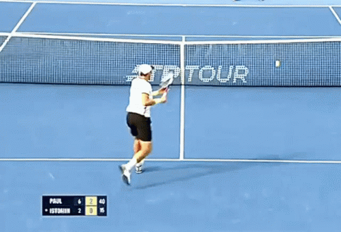 Tennis Player Swinging Racket on Court With AT&T Tour Sign