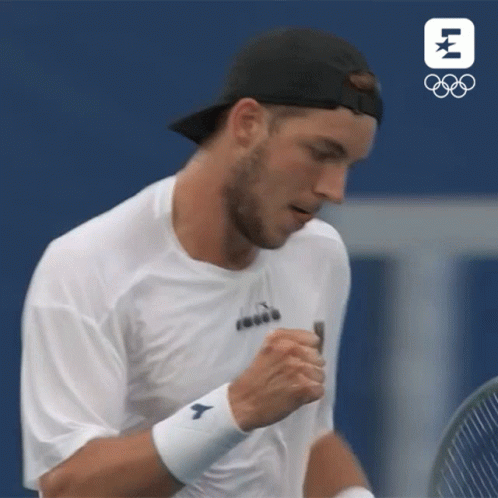 Tennis Player Wipes Face Holding Racquet