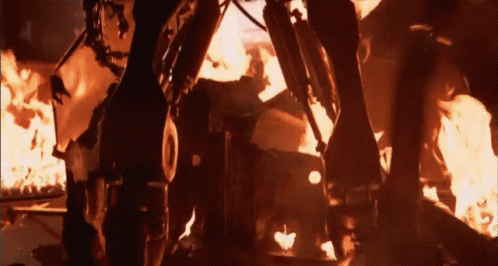 Terminator Skynet Standing In Front Of Fire GIF
