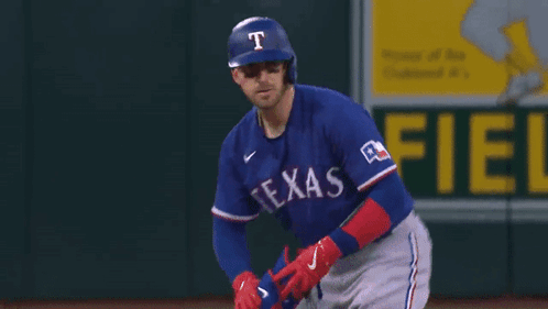 Texas Rangers Baseball Player Wearing Helmet and Gloves
