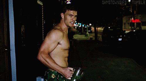 Thad Castle Alan Ritchson Holding Briefcase GIF