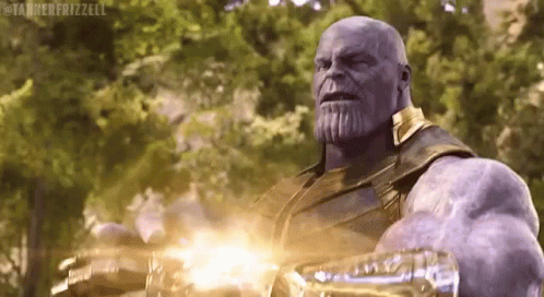 Thanos From Avengers Infinity War Is Holding A Gun In His Hand And Looking At The Camera . GIF