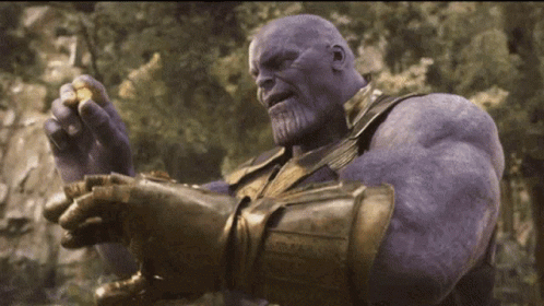 Thanos From Avengers Infinity War Is Holding A Piece Of Gold In His Hand . GIF