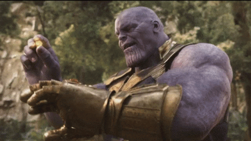 Thanos From Avengers Infinity War Is Holding A Piece Of Gold In His Hands GIF