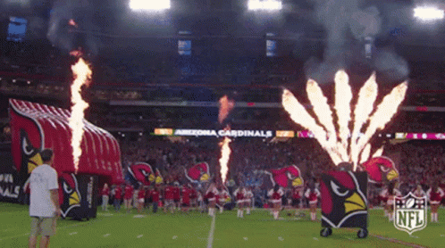 The Arizona Cardinals Cheerleaders Are On The Field With Fireworks GIF
