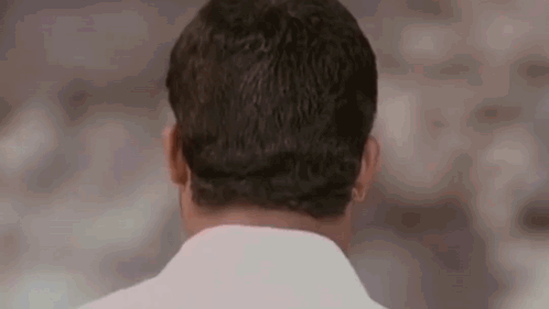 the back of a man 's head is shown in this close up .
