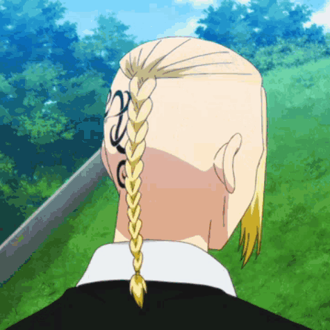 The Back Of A Man 'S Head With A Braid And A Tattoo On His Back . GIF