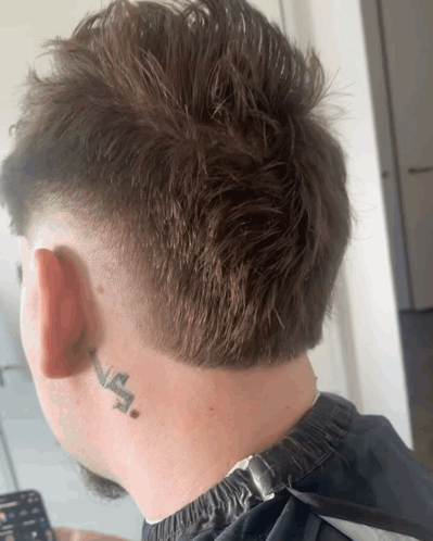 The Back Of A Man 'S Head With A Tattoo On His Neck That Says " Na " GIF