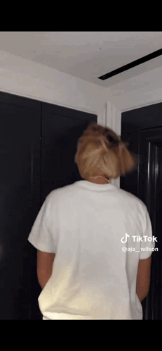The Back Of A Person Wearing A White T-Shirt Is Shown GIF