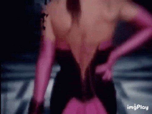 The Back Of A Woman Wearing A Black Dress And Pink Gloves . GIF