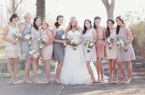 The Bride And Her Bridesmaids Pose For A Photo GIF