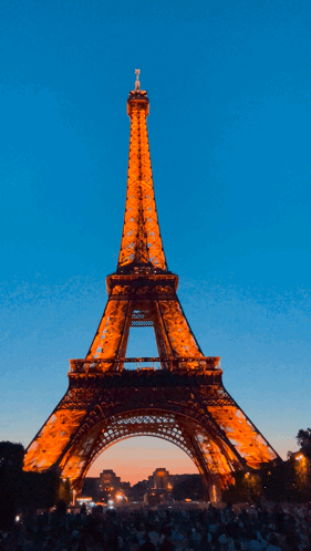 The Eiffel Tower Is Lit Up At Night GIF