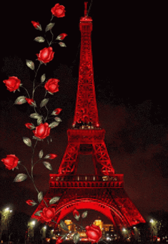 The Eiffel Tower Is Lit Up With Red Lights At Night GIF