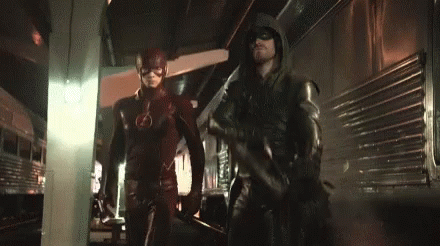 The Flash And Green Arrow Are Standing Next To Each Other In A Dark Room . GIF