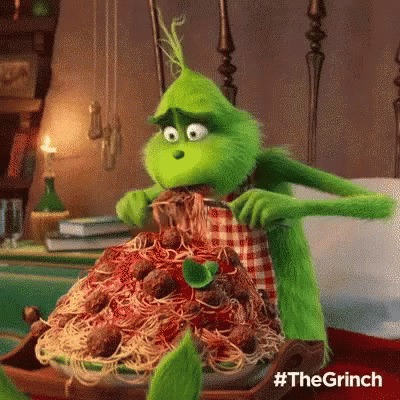 The Grinch From The Movie The Grinch Is Eating Spaghetti And Meatballs On A Plate . GIF