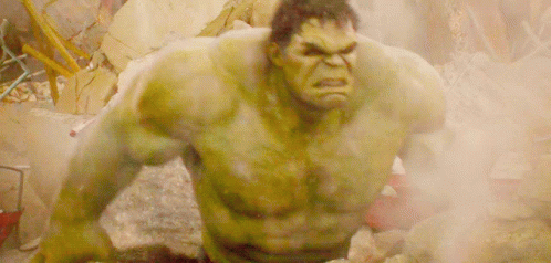 The Hulk Is Standing In A Pile Of Rocks And Smoke GIF