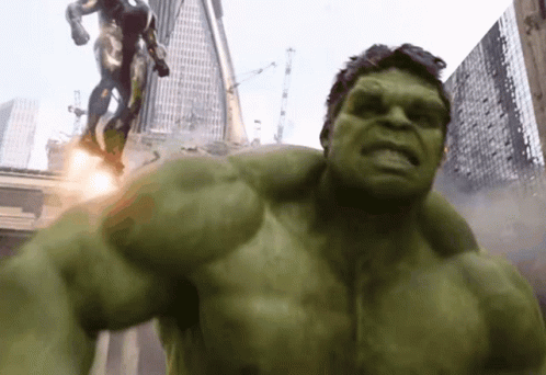 The Hulk Is Standing In Front Of A Statue Of A Man GIF