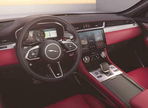 The Interior Of A Jaguar Car Has A Steering Wheel GIF