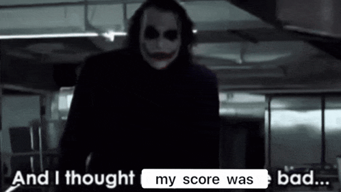 The Joker From The Movie The Dark Knight Rises Is Standing In A Dark Room . GIF