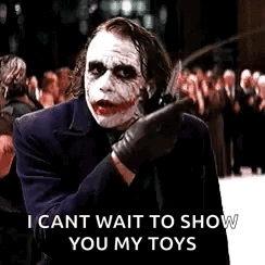 The Joker Is Holding A Knife And Pointing At Someone . GIF
