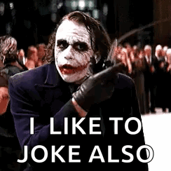 The Joker Is Holding A Knife And Says `` I Like To Joke Also '' While Standing In Front Of A Crowd . GIF