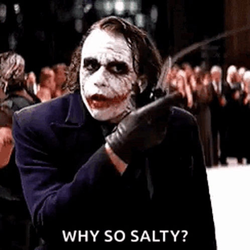 The Joker Is Holding A Knife In His Hand And Pointing At Someone . GIF