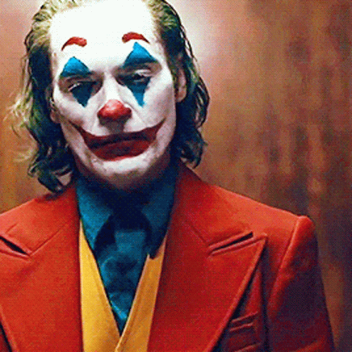 Joker In Red Suit And Blue Tie GIF
