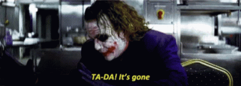 The Joker Says Ta-Da It 'S Gone In A Dark Room . GIF