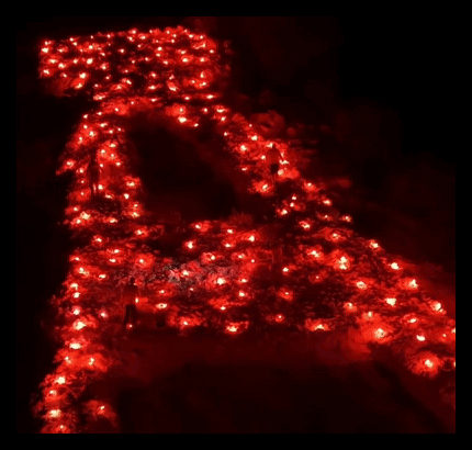 the letter a is lit up in red candles