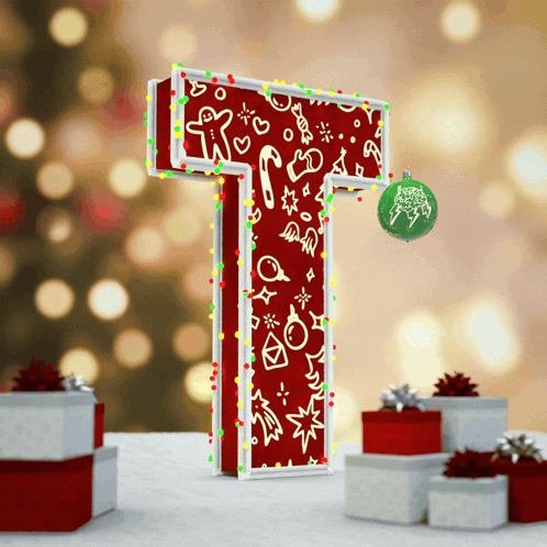 The Letter T Is Decorated With Christmas Lights And A Christmas Ornament GIF