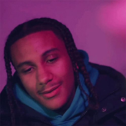 The Man Is Wearing A Blue Hoodie And A Black Jacket And Is Smiling . GIF