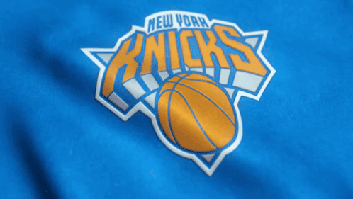 The New York Knicks Logo Is On A Blue Shirt GIF