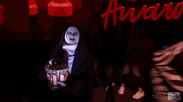 The Nun Eating Popcorn GIF
