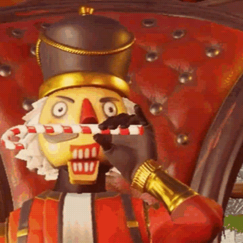 The Nutcracker Is Holding A Candy Cane In His Mouth . GIF
