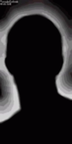 The Silhouette Of A Person With Red Eyes And A Smile On Their Face . GIF