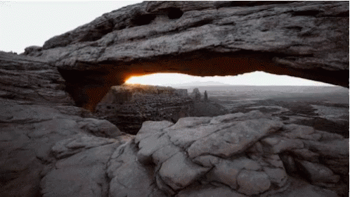 The Sun Is Shining Through A Rock Arch GIF