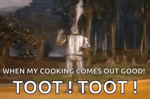 The Tin Man From The Wizard Of Oz Is Standing In The Woods And Smoking A Pipe . GIF