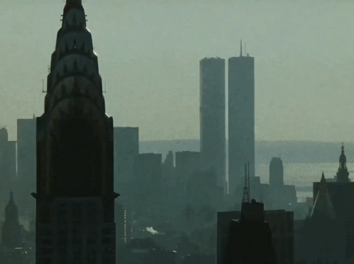 The Twin Towers Of The World Trade Center Are Visible In The Background GIF