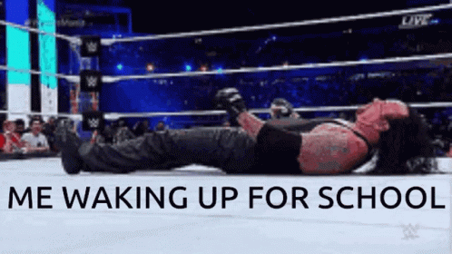 the undertaker is laying on the ground in a wrestling ring