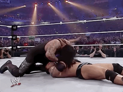 The Undertaker Pushing His Opponent Hands GIF