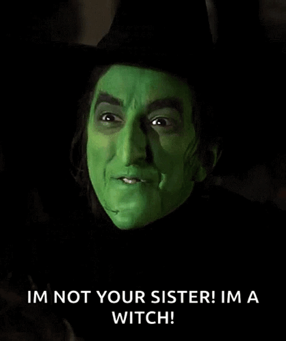 The Wicked Witch From The Wizard Of Oz Is Wearing A Black Hat And Green Makeup . GIF