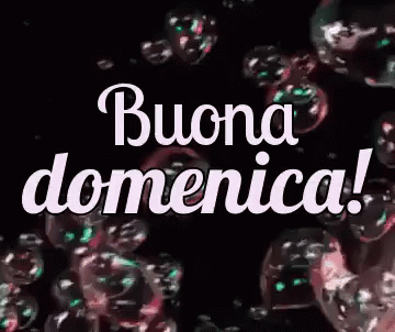 The Word Buona Domenica Is Surrounded By Soap Bubbles On A Black Background . GIF