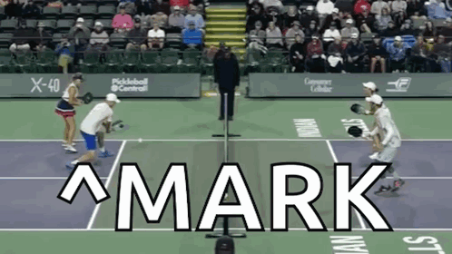 The Word Mark Is On A Tennis Court With People Playing GIF