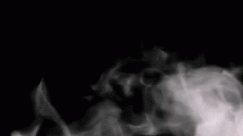 The Word Now Is Surrounded By Smoke In A Black Background GIF